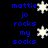 Blue pixelated text reads "mattie jo rocks my socks" with white snowflakes on a black background, animated to shift positions.