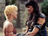 Two pixelated figures face each other; one has blonde hair and light skin, the other dark hair and darker clothing against a muted background.