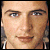 pixelated facial portraits with varying expressions and clothing, some displaying 'WESTLIFE FAN' text on dark brown backgrounds