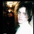A 48x48 pixel buddy icon featuring a low-resolution image of a person with dark hair and light clothing on the left, paired with orange text reading "i wanna be a Kennedy then I'd be a big heart breaker live fast and for real" arranged in multiple lines against a black background.