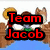 Pixelated image with red and black text overlays on a cartoon background featuring characters in brown outfits.