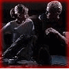 A sequence of showing two people in a dark setting, with one person leaning toward the other in various poses