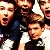 Pixelated static image of multiple people in close proximity with varied expressions and clothing colors, rendered at low resolution.