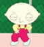 Animated cartoon character with large head, yellow shirt, red overalls, and white shoes stands against green chain-link fence background.
