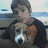 A pixelated image shows a person holding a dog with a white and brown face, overlaid with red text reading "IT IS ME AND MACEY" on a black background.