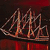 A pixelated static image of a stylized sailboat with multiple masts on dark water under a red sky.