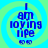 Blue text reading "I am loving life" with two small smiley faces on a green and blue spiral background.