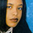 Pixelated close-up of a person with long dark hair against blue and black background, static single-frame image.