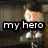 Animated pixel art of a character with dark hair and glasses, wearing a green vest over white shirt, seated at a table with hands clasped.