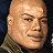 Pixelated buddy icon split into two sections: left side shows a bald man's face in military uniform, right side displays green text on dark background.