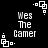 Black background with white pixelated text "Wes The Camer" and small square corner decorations in a
