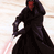 Static pixelated image of a dark-robed figure holding a glowing red lightsaber against a light background.
