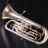 Silver tuba on dark background with red pixelated text reading 'I ROCK AT THE EUPHONIUM' in four segments.