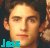 Pixelated close-up of a person's face with light brown hair, neutral expression, and a teal-colored graphic element in the bottom-left corner.