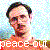 Pixelated image of a person with dark hair and glasses, wearing an orange shirt against a light blue background with scattered colored pixels.