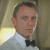 Pixelated close-up of a person in a white dress shirt and black bow tie against a blurred background with light and dark tones.