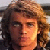 Pixelated image of a person with long brown hair and blue eyes, split into four quadrants with text overlays in red and blue.