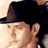 A 48x48 pixel animated contact sheet showing three sequential frames of a person wearing a black fedora hat in various poses and backgrounds.