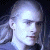 Pixelated close-up of a person's face with light skin tone, dark hair, and dark clothing against a dark background.