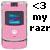 A pink flip phone with a small screen showing blue and purple hues, next to pixelated text reading '<3 my razr' on a white background.