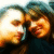 Two people in close proximity with one person's head tilted toward the other, visible in a pixelated, low-resolution image with warm color tones.