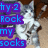 A pixelated image of a cat with text overlays in blue and pink on purple backgrounds.
