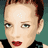 Pixelated portrait of a person with short brown hair and red lipstick, surrounded by repeated text phrases on dark background.