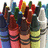 Pixelated image of multiple crayons with visible text 'bee' and 'Different!' on green backgrounds.