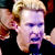 A pixelated image of a person with blonde hair in two stacked , with a blue and gray background containing text