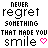 Pixelated text reads 'NEVER regret something that made you smile' with a pink heart on the left and green heart on the right, both static.
