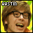 A pixelated image of a person with brown hair and glasses, wearing an orange shirt against a yellow background, with the text 'AUSTIN' at the top left.