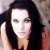 A pixelated image of a person with long dark hair resting their head on one hand, next to green text reading 'Original Icons .com' in bright green letters.