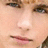 A static image with a bright pink background, featuring a cropped close-up of a person's face on the left and three green text labels on the right.