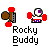Pixelated character with brown body and red limbs, white torso with blue stripes, purple eye in circular head, positioned above 'Rocky Buddy' text.