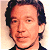 A 50x50 pixel AIM buddy icon featuring a celebrity mugshot-style image with green text overlays on a white background, part of an animated contact sheet.