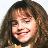 Pixelated close-up of a person with long brown hair, closed eyes, and a slight smile against a light background.