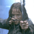 A pixelated figure with long dark hair holds a small object near their mouth against a blue sky background.