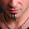 repeated close-up images showing a person's lower face with a lip ring, silver chain necklace, and pixelated text overlay