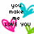 Pixelated image with black text reading 'you make me love you' over three colored heart shapes on white background.