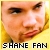 Pixelated close-up of a person's face with light brown hair against yellow background, text 'SHANE FAN' at bottom.