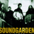 Pixelated image of a dark figure with a large white circular object, green foliage, and yellow text reading "SOUND DEAFEN" at the bottom.