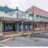 Pixelated static image of a building with multiple windows and a roof, featuring teal, brown, and pink color blocks.
