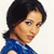 Static pixelated image of a person with dark hair and blue clothing against a light background.