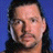 Pixelated static image of a person with dark hair against blue background, wearing light-colored earpiece.