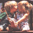 Pixelated image of two people kissing with pink text reading "My First Kiss With You" on a black background.