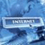 A pixelated blue-toned image shows a rectangular frame with a light border containing the word 'NIGHTMARE' in blocky white letters against a dark background, set over a blurred abstract blue pattern.
