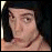 Pixelated meme image split into four quadrants with two human faces and text elements in red, black, and white.