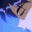 Animated sequence of a character with dark hair and red eyes in blue clothing, transitioning from side profile to front view against light background.