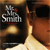 A pixelated image of a person wearing a cap and sunglasses with a 'The Smiths' logo on the cap, transitioning from a side view to a front view.