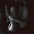 A grayscale animated icon shows a stylized figure with a raised arm and curved body against a dark background, with a light gray on the right